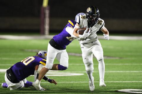 Luke Flowers (35) dragging a Longhorn on one of 12 carries for 52 yards