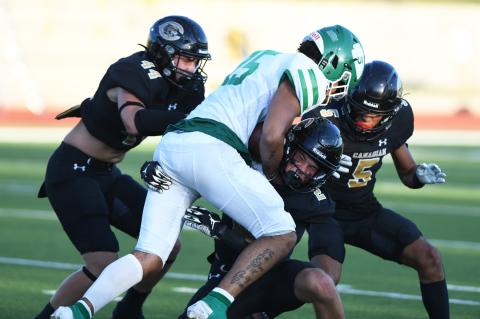 Canadian's Wyatt Davis (44), Julian Dominguez (5) and Trace Mitchell (2) zero in on Seminole WR Braylen Jefferson