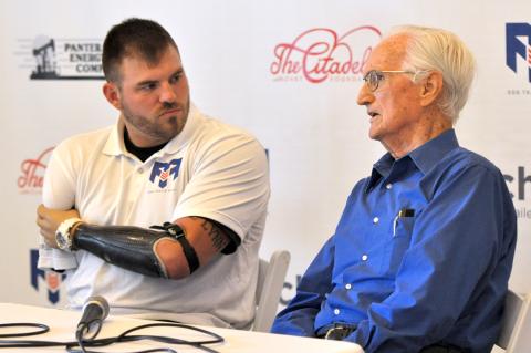 Travis Mills (left) and the late Denzil Leonard were both combat veterans, and both were gravely wounded in wars decades apart. They met and shared an audience together at the Citadelle Art Museum in October 2014.