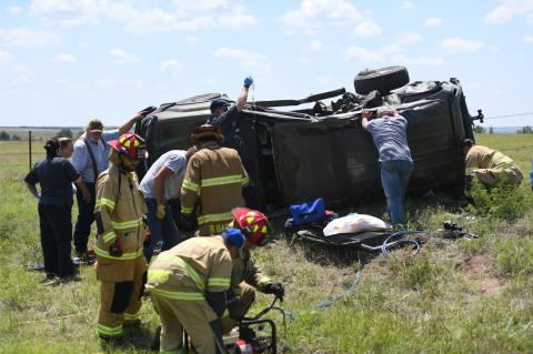 On SH 33, Tuesday, paramedics and firefighters work to stabilize vehicle so that driver can be safely extricated