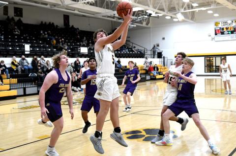With an assist from Reagan Cochran (15), Nathan Wagner (5) gets a shot at the basket