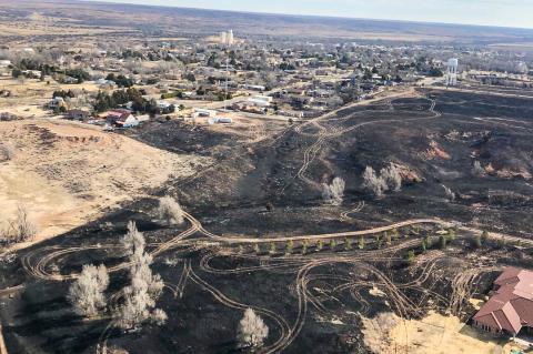 Hemphill County’s Flap-Air Helicopter pilot Trey Webb flew over the Beaver County wildfire Sunday and caught this image that illustrates just how close the flames came to causing much greater destruction of homes and other structures in the community.