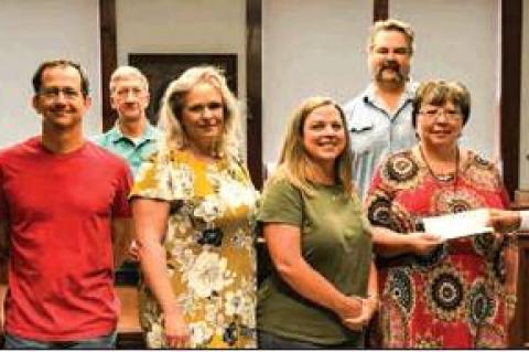 RACHEL’S LITTLE HOUSE: Canadian Area Legacy Fund rep. George Briant (at right in photo) presents a $7,000 check to Rachel’s Little House; (left to right) CALF reps. Sherye Talley, Larry Smith, and Terrill Bartlett; RHL board members, Wendy Wright, Julie Harper, and Britt Sturgeon; and RLH Director Cesali Ericson.