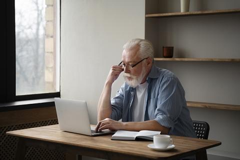 Elderly man working on laptop