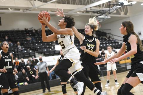 Lady Cat Mattie Boyd (5) drives in for the shot in Canadian's big win over the Plainview Lady Raiders on Friday