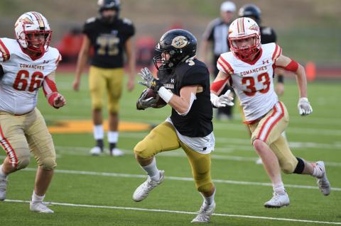 Twister Kelton (3) eludes Comanche defenders Chase Keener (66) and Dawson Bevins (33)