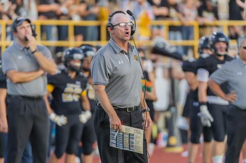 Head Coach Chris Koetting (above) shouts a play into his quick-strike offense