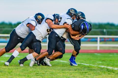 Wildcat defenders Jake Krehbiel (22), Israel Guerrero (42), Rhet Pennington (55) and Fernando Perez (60) tackle Fritch’s Hunter Athey (11)