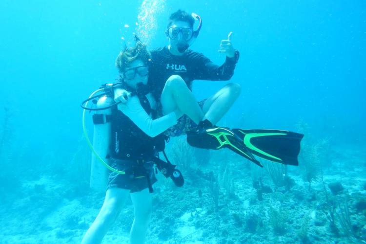 Everett free-diving with friend Harrison (wearing scuba gear) in the Bahamas
