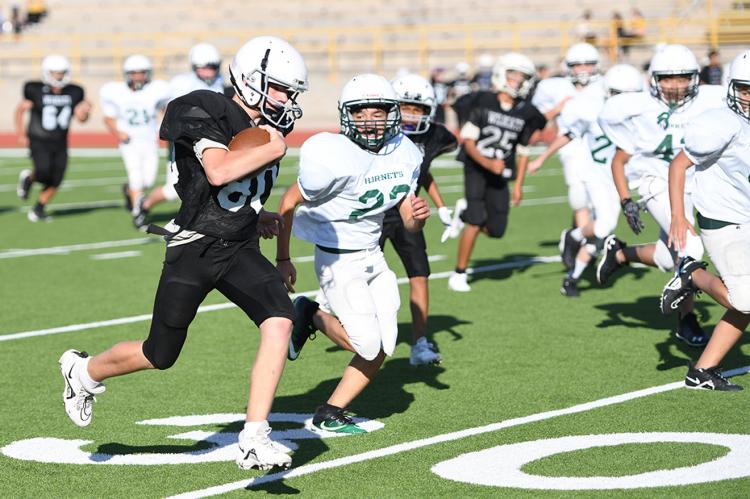 Seventh-grader Aiden Gerhardt (80) covers half the field on this TD run 