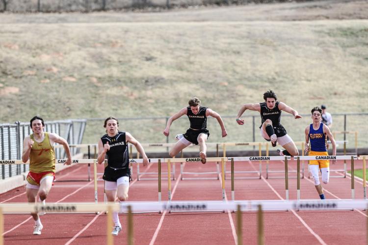 Twister Kelton, Bill Koetting, and Grant McCook in the 300-meter hurdles