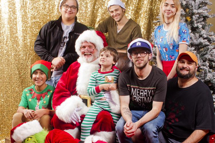 Pictured in the above photo are the happy elves of “Pictures with Santa:” (back row) Sam Fry, Joshua Monty, and Annie Messner; (front) Victor Meraz Jr., Santa with Atticus Weeks, Brandon Russell, and Ray Weeks; and (reclining) Victor Meraz as The Grinch.