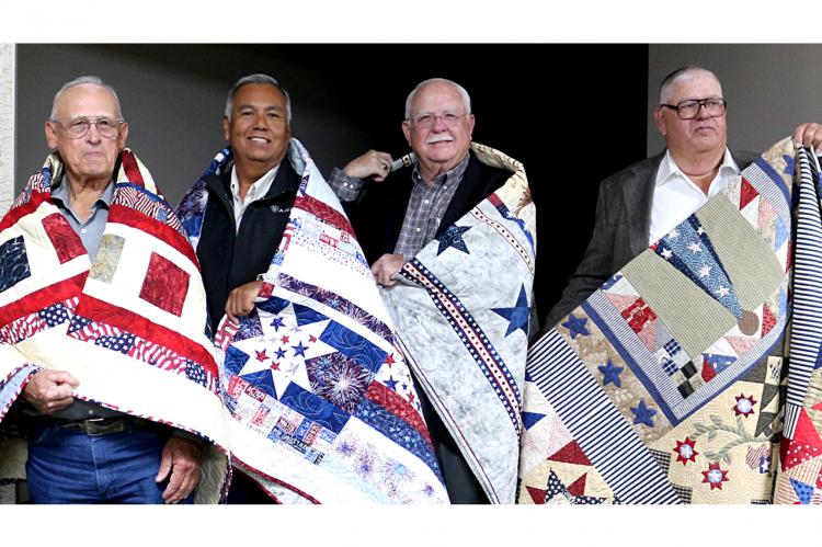 The Friendship Quilt Guild, based in Perryton, made a presentation of 24 Quilts of Valor on Oct. 15 at the Community Worship Center. Four veterans from Canadian received quilts: (l-r) Warren Rivers, Alfred Godino, John McGarr, and John W. Floyd