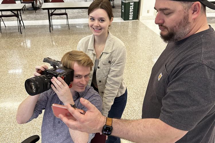 Media Minds members Justin Lovell, from left, Ali Hunter and Paul Torres film a marketing video in the Jack B. Kelley Student Center.