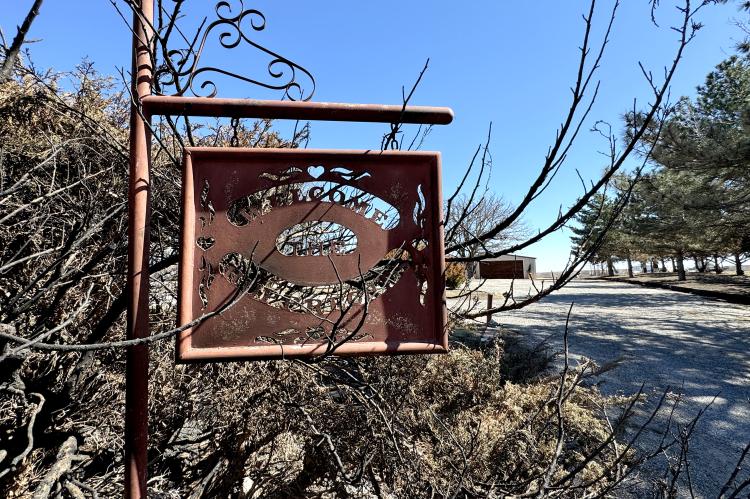 A welcome sign in the drive at the now-empty site of Benny and Connie Rupprecht's home
