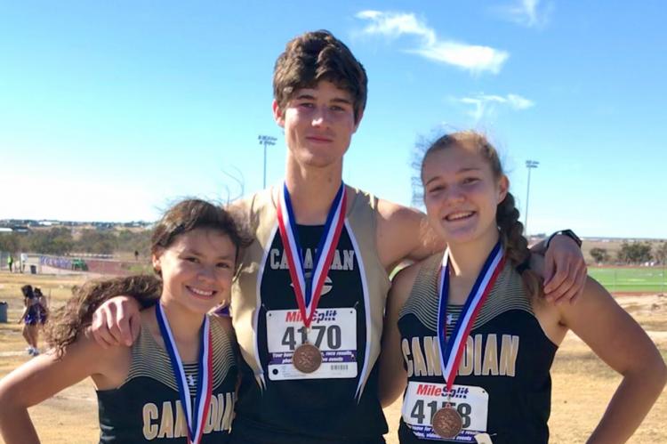 Rylun Clark is flanked by fellow regional-qualifiers Kathia Aragon (left) and Abi Black following the District 1-3A cross-country meet at Canyon. The three athletes will represent Canadian High School at the regional meet next Monday, Nov. 9, in Lubbock.