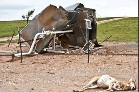 Thursday’s tornado caused havoc at this FourPoint location just off the Booker Highway, twisting heavy metal oil tanks and ladder (at top), and mangling a meter house (above). Even this pronghorn antelope, lying in the foreground, could not outrun the twister’s deadly reach.