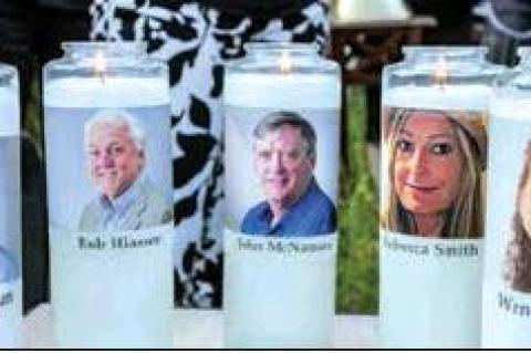 Candles with the faces of the five employees who were killed were used at a gathering of mourners for the employees killed in the Capital Gazette newsroom, Annapolis, Maryland. PHOTO Y KARL MERTON FERRON | THE BALTIMORE SUN