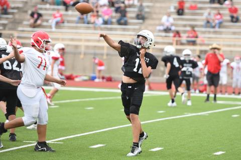 Weston Mitchell (12) sends up a pass in Thursday's win over Perryton