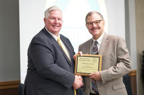 Andy Holloway receives the Achievement Award from NACAA President Phil Durst.
