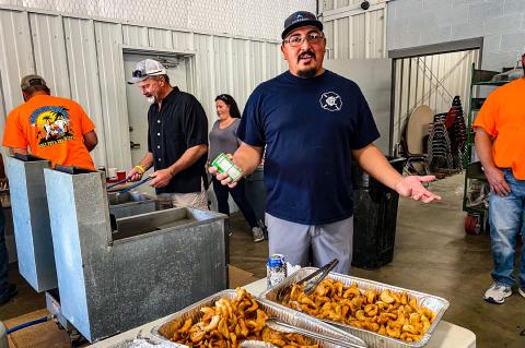 At last year’s Canadian River Beach Club Cook-Off, Juan Guillen welcomes calf fry connoisseurs to sample some fried potatoes as his fellow chefs wait for the piece de resistance to reach the perfect golden hue before serving them up. 