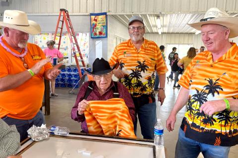 CRBC members Lance Cates, Doug Benge, and John Julian present Calf Fry and domino devotee Bob Durham with his own Beach Club shirt.