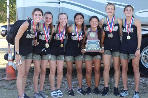 District Cross-Country Champions Ella Walser, Peyton Lee, Konnar McClendon, Elizabeth Guerrero, Kathy Aragon, Arionna Black and Brooklyn Beedy show off the trophy they captured Wednesday at Palo Duro Lake in Spearman.