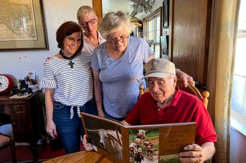 Dawn Dial, Remelle Farrar, and Geri and Dick Wilberforce get their first look at Dick's newest book