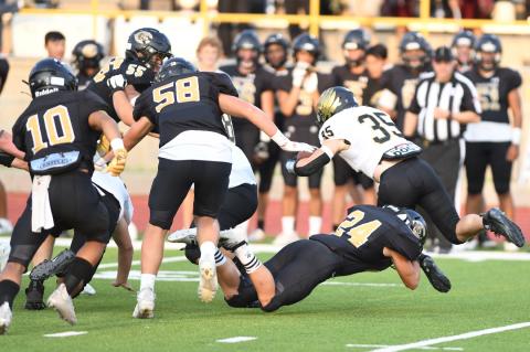 With backup from Isay Ramirez (10), Nathan Mondragon (55) and Nathan Wagner (58), Matt McLanahan (24) stops Bushland's Caden Junell before he finds a hole.