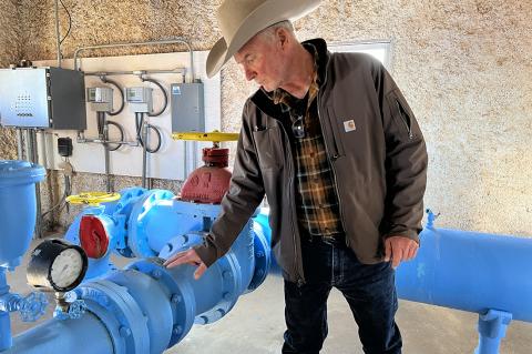 City Manager Joe Jarosek inspecting a valve at the pump house