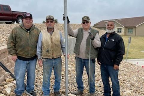 Jason Bradford, Warren Rivers, John McGarr, and Alfred Godino with the flagpole installed
