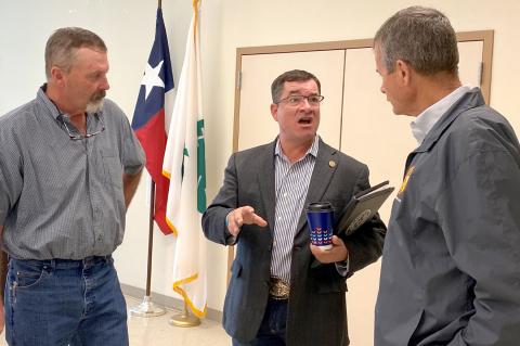 County Commissioner Curt McPherson and Judge George Briant visit with state Rep. Ken King following town hall