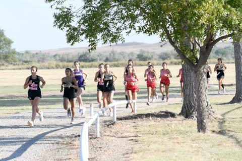 Varsity girls circle the Hemphill County Sports Complex on Saturday on the first leg of their 2-mile run