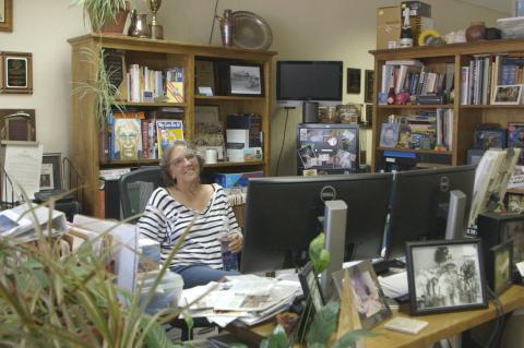 Record Editor/Publisher Laurie Ezzell Brown at her typically messy desk.