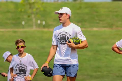 Canadian senior-to-be Luke Flowers works a drill with fourth grader Kason Richardson during Flowers’ Way of the Wildcat Skills and Leadership Camp last week.