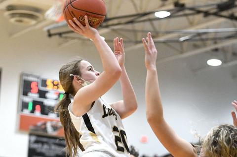 Tinley Pennington (20) attempts a layup and draws the foul from Chanie Chambers (20)