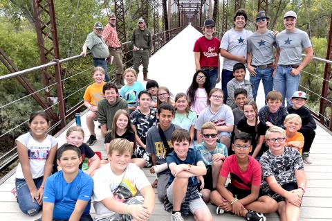 CMS fifth-graders on the Canadian River Wagon Bridge with their water festival guides