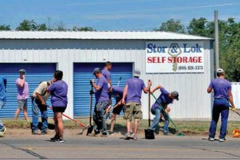Members of the Church of Christ and First Christian Church worked along the highway, fixing broken concrete, uncovering sidewalks, and edging and mowing along the highway, Saturday, July 19 for Go! Weekend.